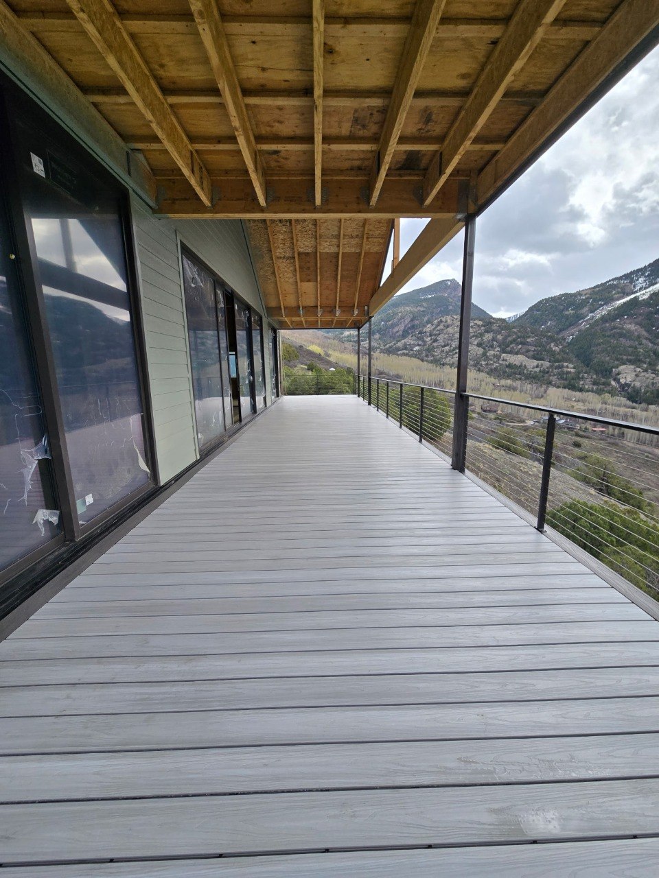 Completed floor-to-ceiling window wall and deck