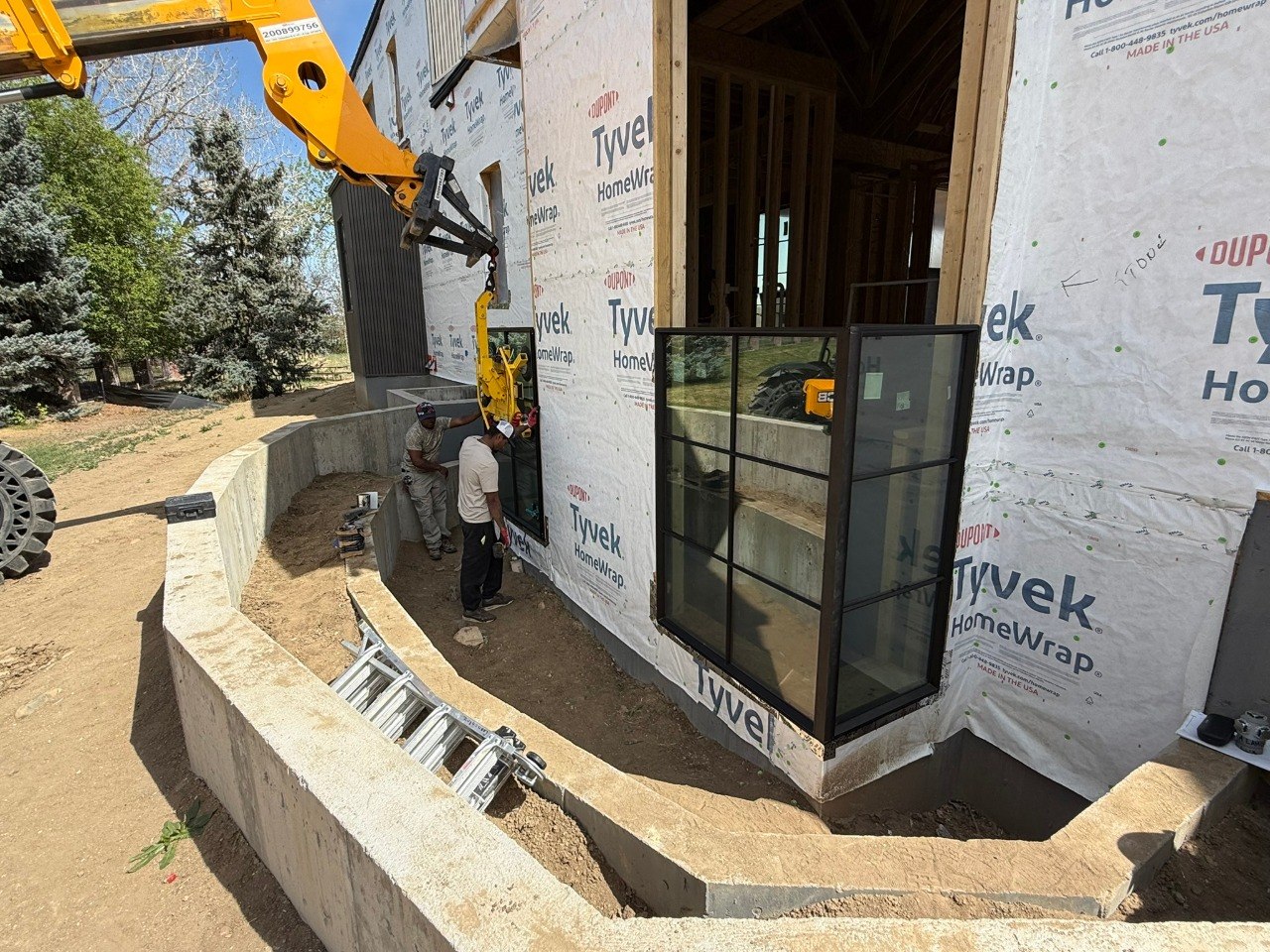 Black grid window installation from exterior job site