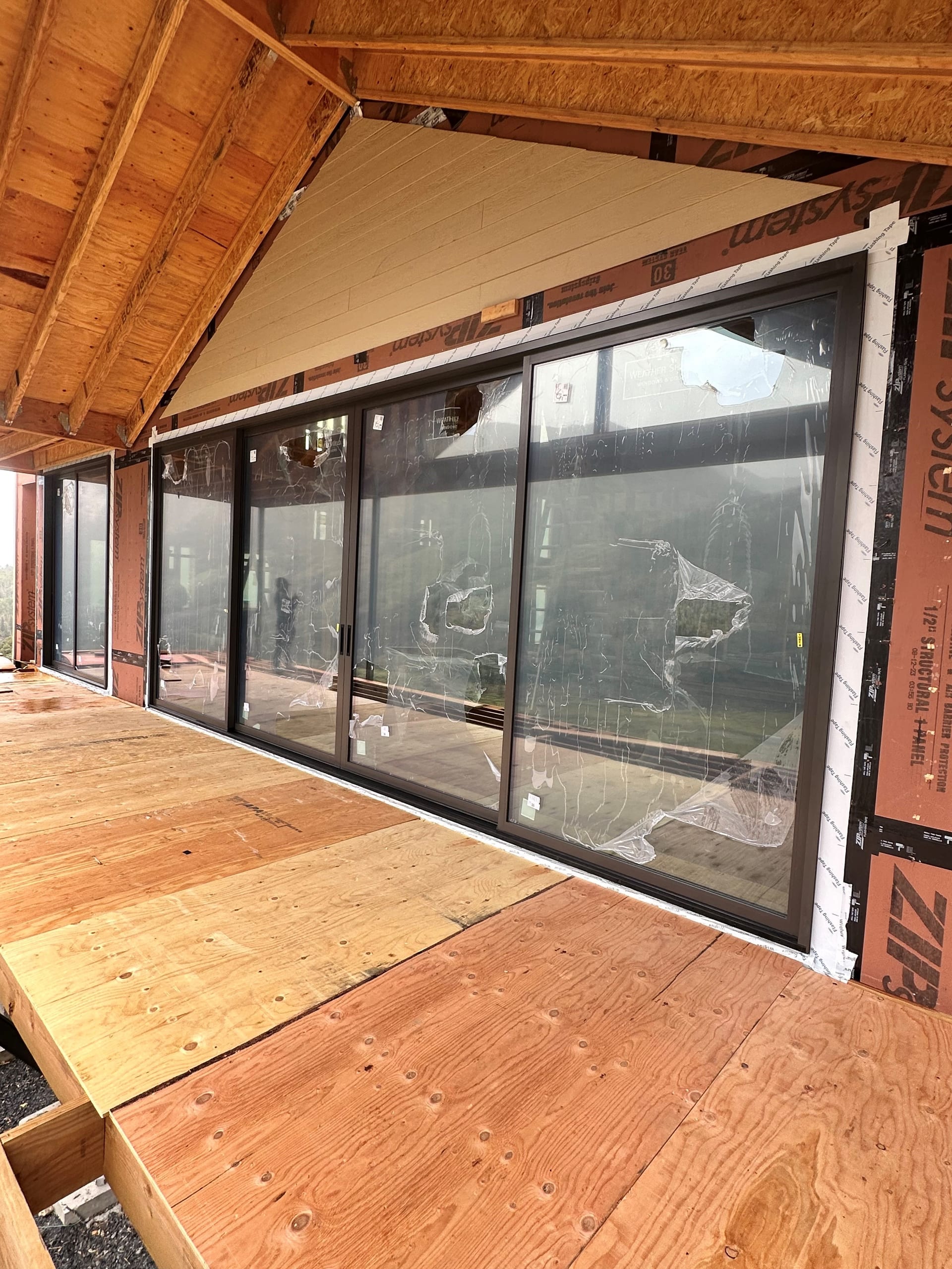 Weather Shield Mountain Modern Residence - multi-panel sliding door wall under construction