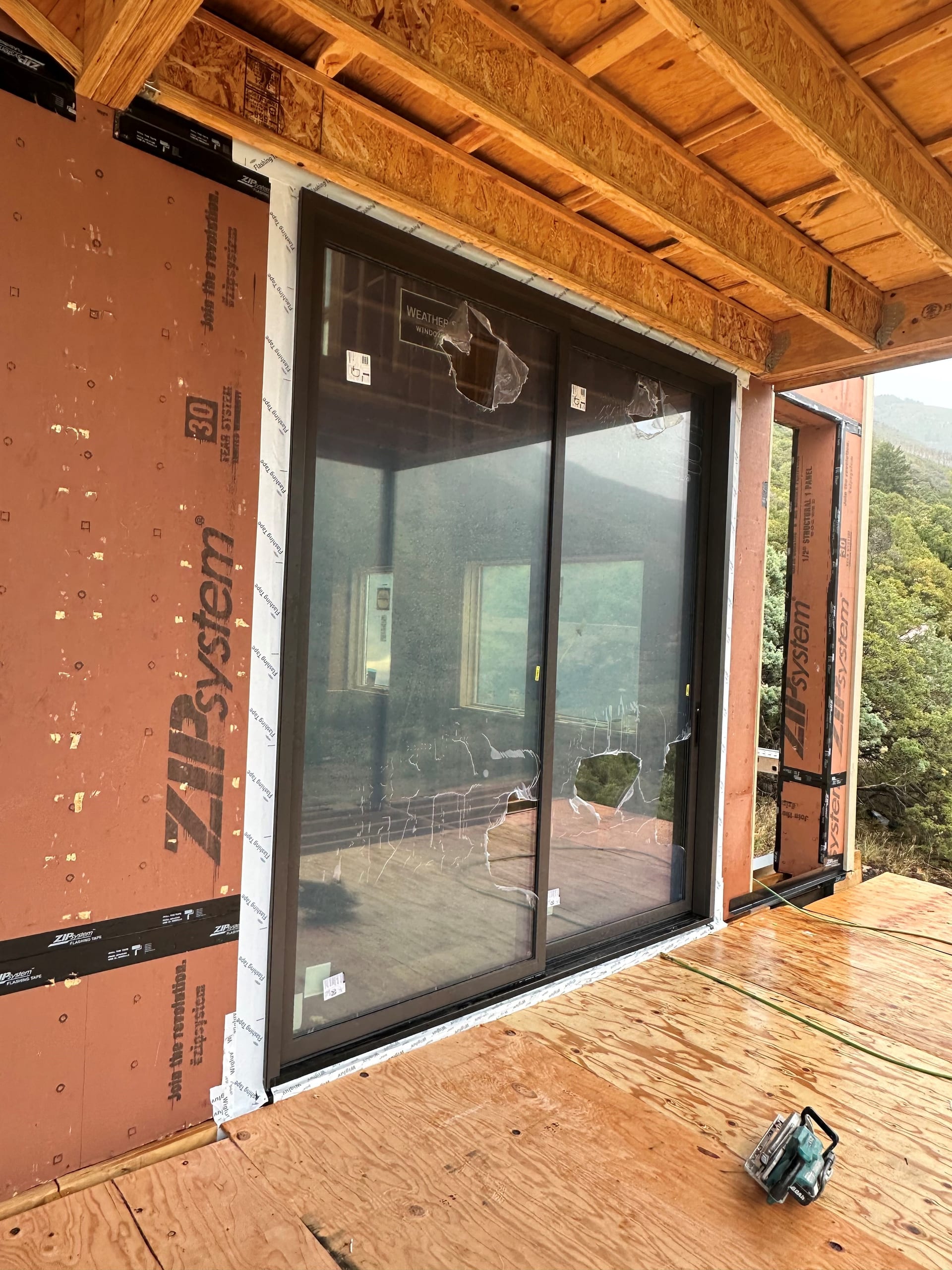 Weather Shield Mountain Modern Residence - Weather Shield sliding door with mountain backdrop