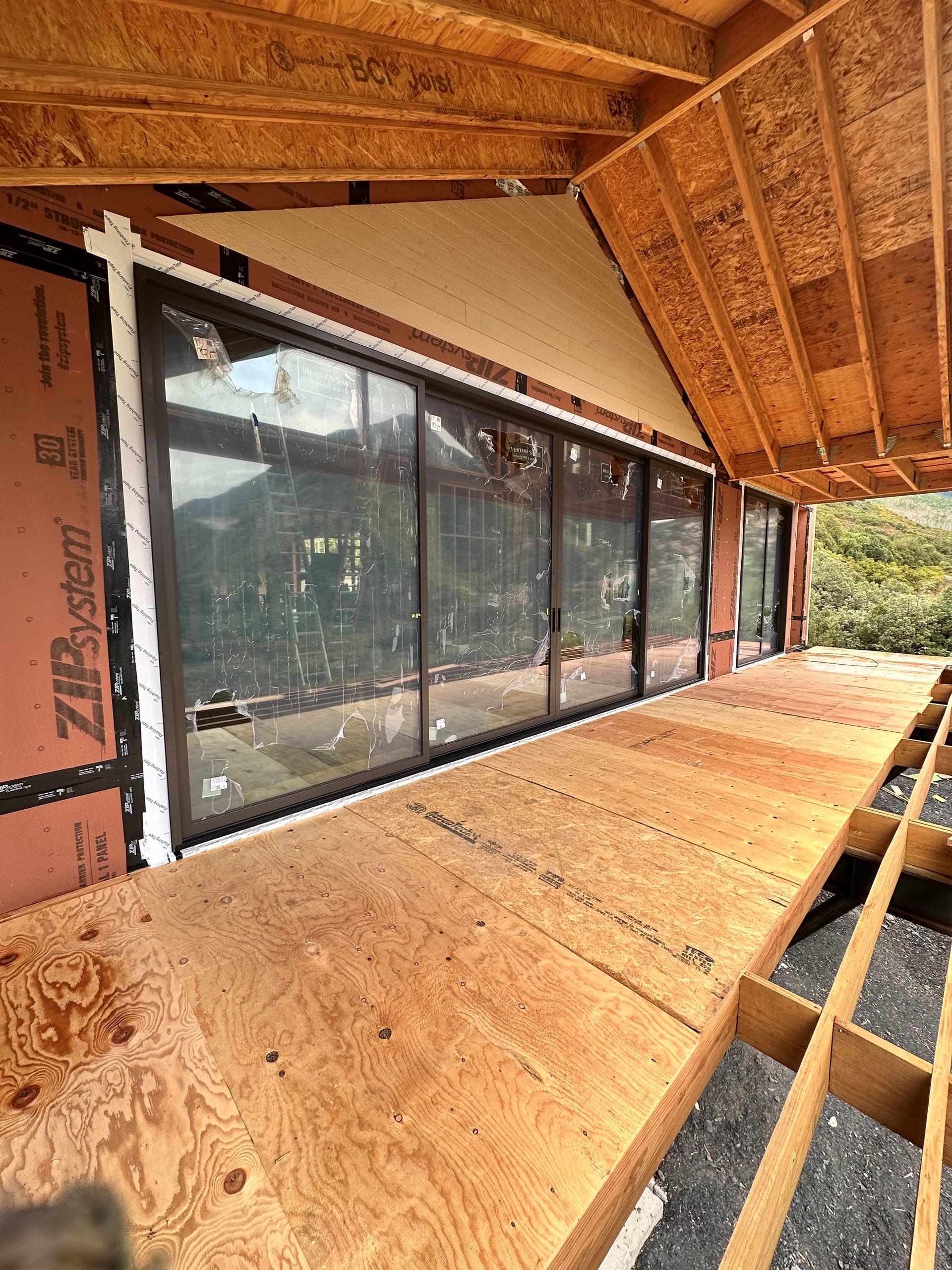 Weather Shield Mountain Modern Residence - covered deck and sliding doors